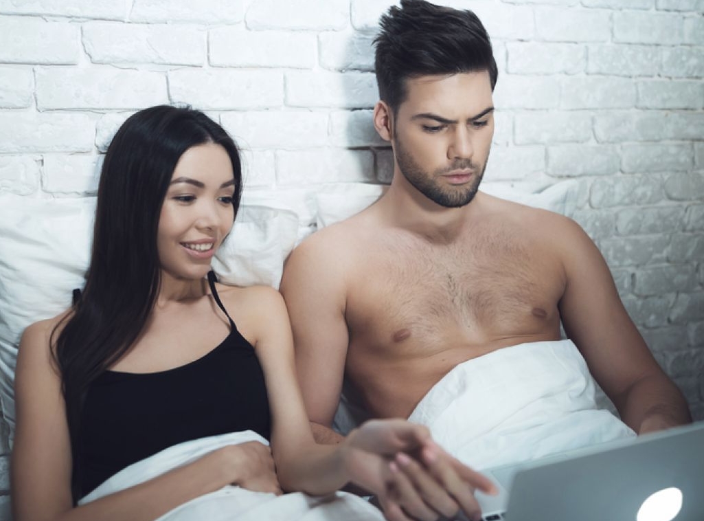 couple in bed with laptop
